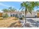 Charming single-story home with well-manicured landscaping and a welcoming front porch, with a two car garage at 8419 Sylvan Woods Dr, Sarasota, FL 34243