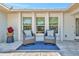 Charming front porch with wicker seating, providing an inviting outdoor living space at 8419 Sylvan Woods Dr, Sarasota, FL 34243