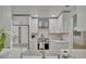Modern kitchen featuring white cabinets, stainless steel appliances, stylish backsplash, and a farmhouse sink at 8419 Sylvan Woods Dr, Sarasota, FL 34243