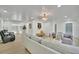Bright and airy living room featuring stylish furniture, decor, and wood-look flooring at 8419 Sylvan Woods Dr, Sarasota, FL 34243