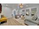 Cozy living room featuring hardwood floors, neutral tones, comfortable seating, and ample natural light at 8419 Sylvan Woods Dr, Sarasota, FL 34243