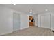 This versatile living space features a kitchenette, neutral walls, and new wood-look floors at 8419 Sylvan Woods Dr, Sarasota, FL 34243