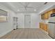 This versatile living space features a kitchenette, neutral walls, and new wood-look floors at 8419 Sylvan Woods Dr, Sarasota, FL 34243