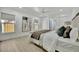 Bright main bedroom features a ceiling fan, wood-look floors, and a contemporary decor at 8419 Sylvan Woods Dr, Sarasota, FL 34243