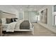 Spacious main bedroom with wood-look floors, ample closet space, and neutral decor at 8419 Sylvan Woods Dr, Sarasota, FL 34243