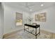 Bright home office featuring a modern desk, chair, ceiling fan, and neutral decor at 8419 Sylvan Woods Dr, Sarasota, FL 34243