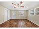 Spacious living room with hardwood floors, ceiling fan, closet, and natural light at 8470 Magnolia Dr, Seminole, FL 33777
