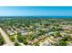 Aerial view of a neighborhood with a pool and ocean views in the distance at 914 82Nd Nw St, Bradenton, FL 34209