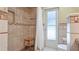 Bathroom featuring tiled shower with bench, safety rails, and frosted glass door at 914 82Nd Nw St, Bradenton, FL 34209