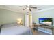 This bedroom features a ceiling fan, neutral walls, and an adjacent bathroom at 914 82Nd Nw St, Bradenton, FL 34209