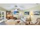 Inviting living room with a beamed ceiling, ceiling fan, and beach-themed decor at 914 82Nd Nw St, Bradenton, FL 34209