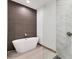 Bathroom featuring freestanding tub and glass-enclosed shower at 102 Arrow Ln, Rotonda West, FL 33947
