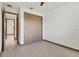Neutral bedroom features a wooden sliding-door closet and wood trim flooring at 102 Arrow Ln, Rotonda West, FL 33947