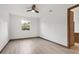 Bright bedroom with tile floors, ceiling fan, and a large window providing natural light at 102 Arrow Ln, Rotonda West, FL 33947