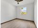 Bright bedroom features a ceiling fan and a sun-filled window view at 102 Arrow Ln, Rotonda West, FL 33947