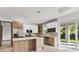 Modern kitchen featuring stainless steel appliances, center island, and light wood and white cabinetry at 102 Arrow Ln, Rotonda West, FL 33947