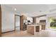 Modern kitchen featuring stainless steel appliances, center island, and light wood and white cabinetry at 102 Arrow Ln, Rotonda West, FL 33947