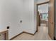 Hallway laundry area with wood trim flooring and access to kitchen area at 102 Arrow Ln, Rotonda West, FL 33947