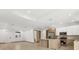Open living space with modern kitchen and living room areas featuring tile floors and recessed lighting at 102 Arrow Ln, Rotonda West, FL 33947