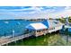 Waterfront restaurant with outdoor seating, docks, and boats creating an inviting atmosphere at 11007 Copperlefe Dr, Bradenton, FL 34212