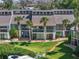 Back exterior of townhomes with balconies, and a well-manicured lawn at 1233 Dockside Pl # 207, Sarasota, FL 34242