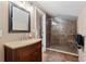 Bathroom featuring a wood vanity, and a glass shower with tiled walls and floors at 1233 Dockside Pl # 207, Sarasota, FL 34242