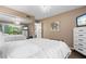 This bedroom showcases a mirrored closet, wood floors, and a flat screen television at 1233 Dockside Pl # 207, Sarasota, FL 34242