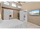 Well-lit bedroom with vaulted ceilings, clerestory windows, and en-suite bathroom at 1233 Dockside Pl # 207, Sarasota, FL 34242