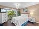 Bright bedroom featuring wood floors, sliding glass doors, and a decorative light fixture at 1233 Dockside Pl # 207, Sarasota, FL 34242