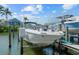 View of a boat on a lift next to a dock and water at 1233 Dockside Pl # 207, Sarasota, FL 34242