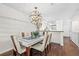 Elegant dining area with modern lighting and a glimpse into the kitchen at 1233 Dockside Pl # 207, Sarasota, FL 34242