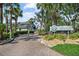 Harbour Towne Yacht Club entrance with lush landscaping at 1233 Dockside Pl # 207, Sarasota, FL 34242