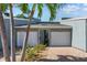 Charming townhome featuring a two-car garage, brick paver driveway and tropical landscaping at 1233 Dockside Pl # 207, Sarasota, FL 34242