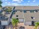 Exterior view of townhomes featuring multi-car garages, modern roofing, and mature palm trees at 1233 Dockside Pl # 207, Sarasota, FL 34242