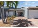 Townhome with a two-car garage, brick paver driveway and tropical landscaping at 1233 Dockside Pl # 207, Sarasota, FL 34242