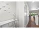 Bright foyer featuring a console table, decorative accents, and hardwood floors leading to the living area at 1233 Dockside Pl # 207, Sarasota, FL 34242