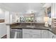 Open kitchen layout with modern appliances, granite countertops, and view of the living area at 1233 Dockside Pl # 207, Sarasota, FL 34242