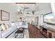 Open living area with a spiral staircase, modern furnishings, and a view into the kitchen at 1233 Dockside Pl # 207, Sarasota, FL 34242