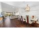 Bright living and dining area featuring wood floors and a spiral staircase to the second floor at 1233 Dockside Pl # 207, Sarasota, FL 34242
