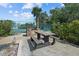 Outdoor picnic area with a stone grill and built-in seating next to a tennis court at 1233 Dockside Pl # 207, Sarasota, FL 34242