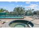 Relaxing community pool and jacuzzi surrounded by brick pavers and lounge chairs at 1233 Dockside Pl # 207, Sarasota, FL 34242
