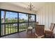 Relaxing screened porch offering serene views of the surrounding landscape and waterway at 1233 Dockside Pl # 207, Sarasota, FL 34242