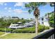 Picturesque waterfront view featuring boat docks, lush greenery, and blue skies from a serene balcony at 1233 Dockside Pl # 207, Sarasota, FL 34242