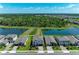 Aerial view of homes, manicured lawns, and serene water features at 12664 Oak Hill Way, Parrish, FL 34219