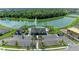 Community pool with clubhouse, parking and beautiful landscaping surrounded by a lake with a fountain at 12664 Oak Hill Way, Parrish, FL 34219
