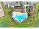 Aerial view of the community pool featuring abundant seating around a beautiful pool and lush landscaping at 12664 Oak Hill Way, Parrish, FL 34219
