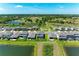 Aerial view showcases a home with a screened patio, a lawn, and water views at 12664 Oak Hill Way, Parrish, FL 34219
