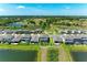 Aerial view showcases a home with a screened patio, a lawn, and water views at 12664 Oak Hill Way, Parrish, FL 34219