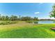 Large backyard with a peaceful pond, perfect for relaxation and enjoying nature's beauty at 12664 Oak Hill Way, Parrish, FL 34219