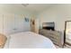 Clean bedroom with ample closet space, a television, and neutral tones for a relaxing atmosphere at 12664 Oak Hill Way, Parrish, FL 34219
